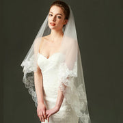 Ivory lace bridal veil with ethereal bow-accent cathedral tulle, lightweight and elegant wedding accessory