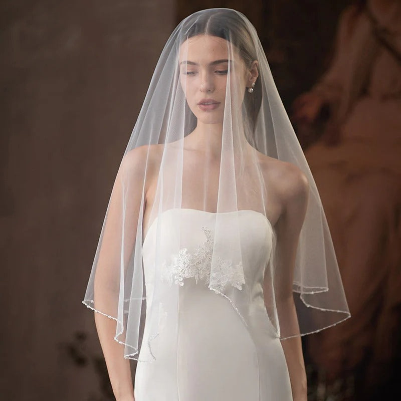 Single-layer beaded lace bridal veil in soft white and beige chiffon tulle, lightweight and elegant wedding accessory