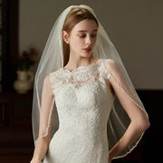 Elegant beaded hair comb with delicate mid-length tulle bridal veil handcrafted from soft chiffon