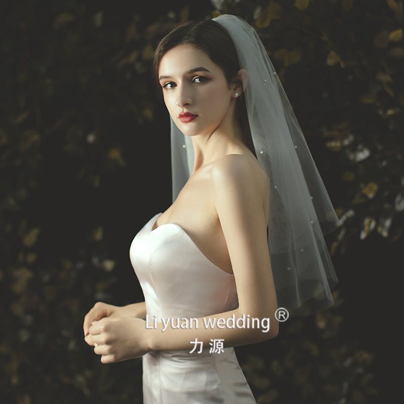 Beaded lace trim bridal veil with bow accent made of soft chiffon tulle