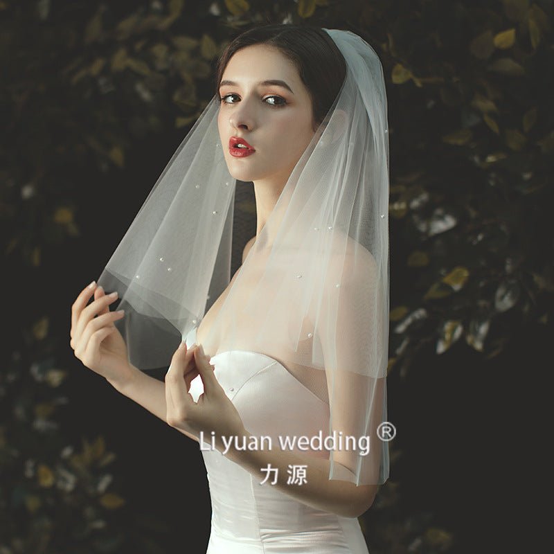 Beaded lace trim bridal veil with bow accent made of soft chiffon tulle