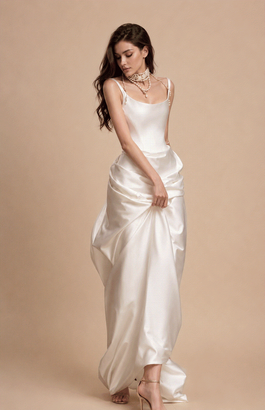 Elegant ivory satin corset gown with pearl accents and flowing floor-length skirt for bridal elegance
