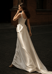 Elegant ivory satin corset gown with pearl accents and low-back design for bridal elegance