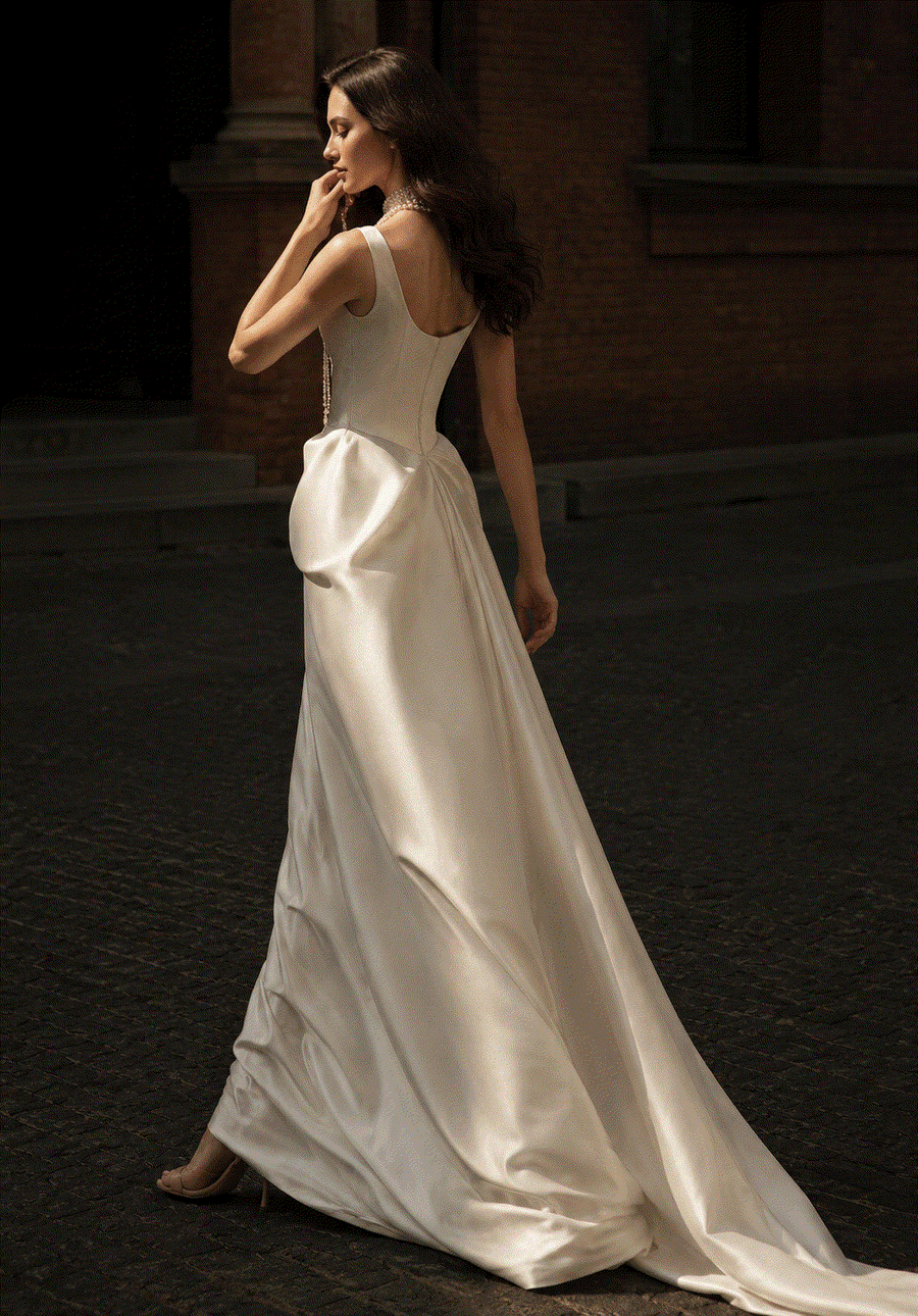 Elegant ivory satin corset gown with pearl accents and low-back design for bridal elegance