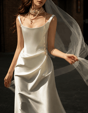 Ivory satin corset gown with pearl accents and low-back design for bridal elegance