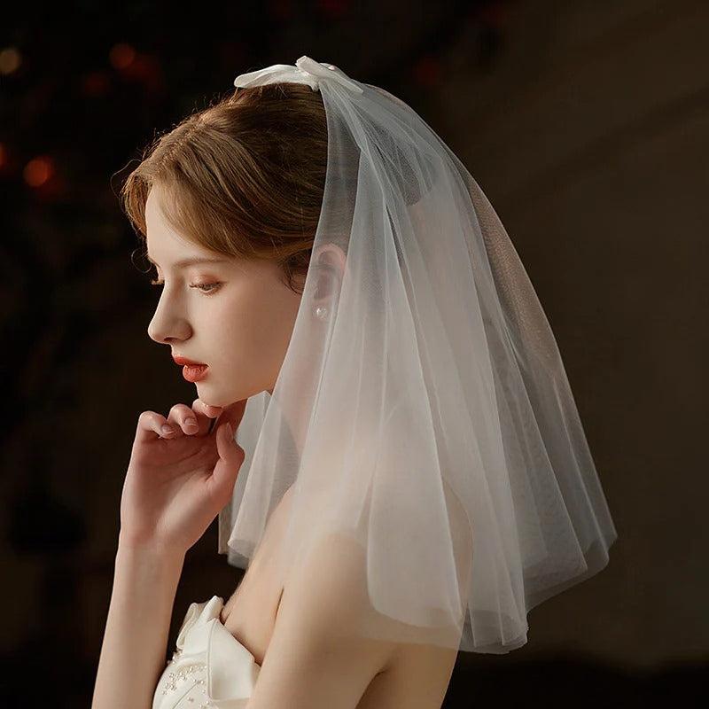 Ivory Bow Bridal Veil made of soft chiffon tulle with elegant knot accent for weddings
