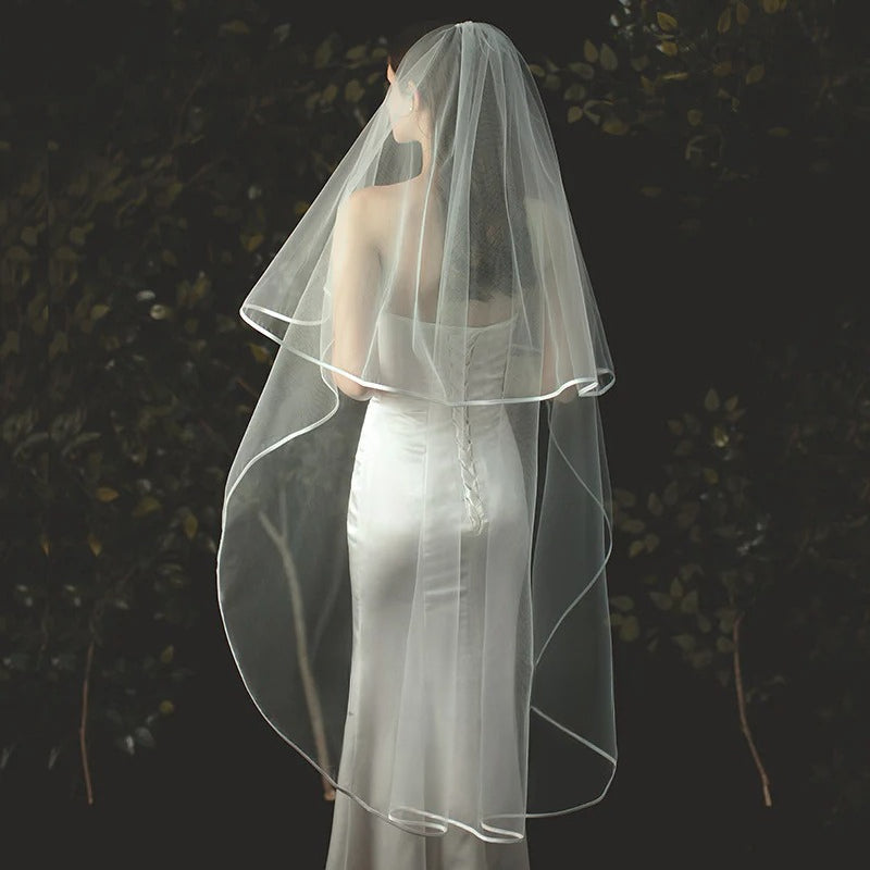 Two-layer pearl beaded bridal veil with Korean style metal hair comb on soft chiffon tulle background