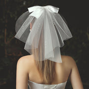 Pearl beaded bow bridal veil on soft sheer chiffon tulle for elegant wedding look