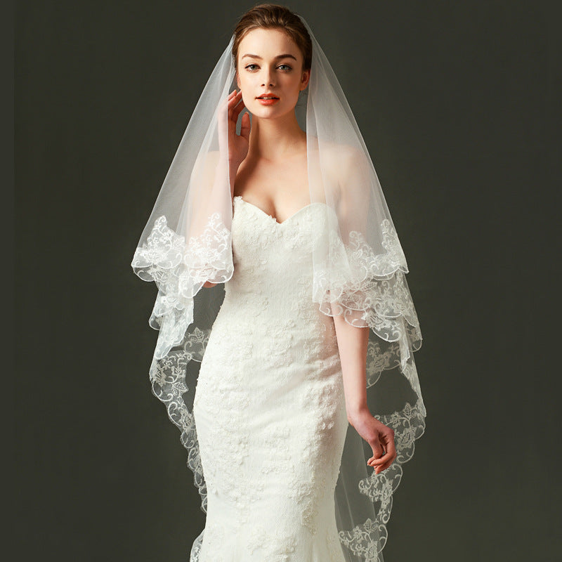 Ivory lace bridal veil with ethereal bow-accent cathedral tulle design on soft chiffon fabric