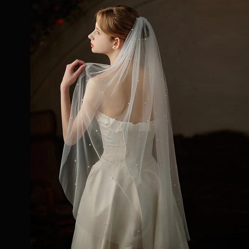Mid-length beaded lace tulle bridal veil made from soft chiffon, showcasing elegant, sheer, and lightweight design for weddings and photography.