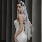 Dramatic lace bridal veil made of soft chiffon tulle with a long, semi-sheer design and hair tie.