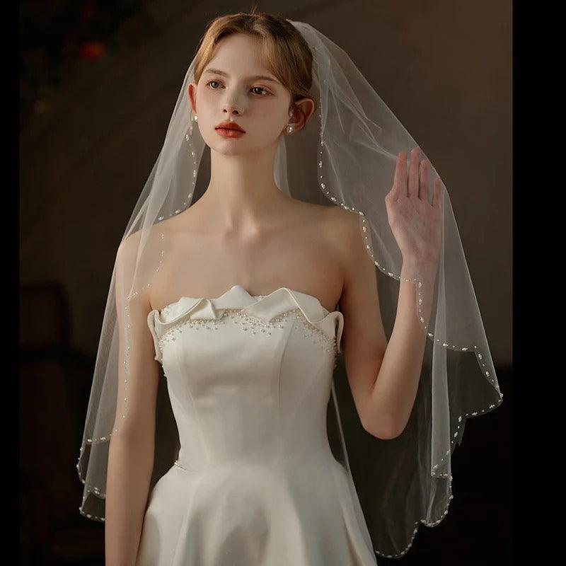 Lace trim bridal veil with soft tulle and delicate comb for mid-length wedding headpiece