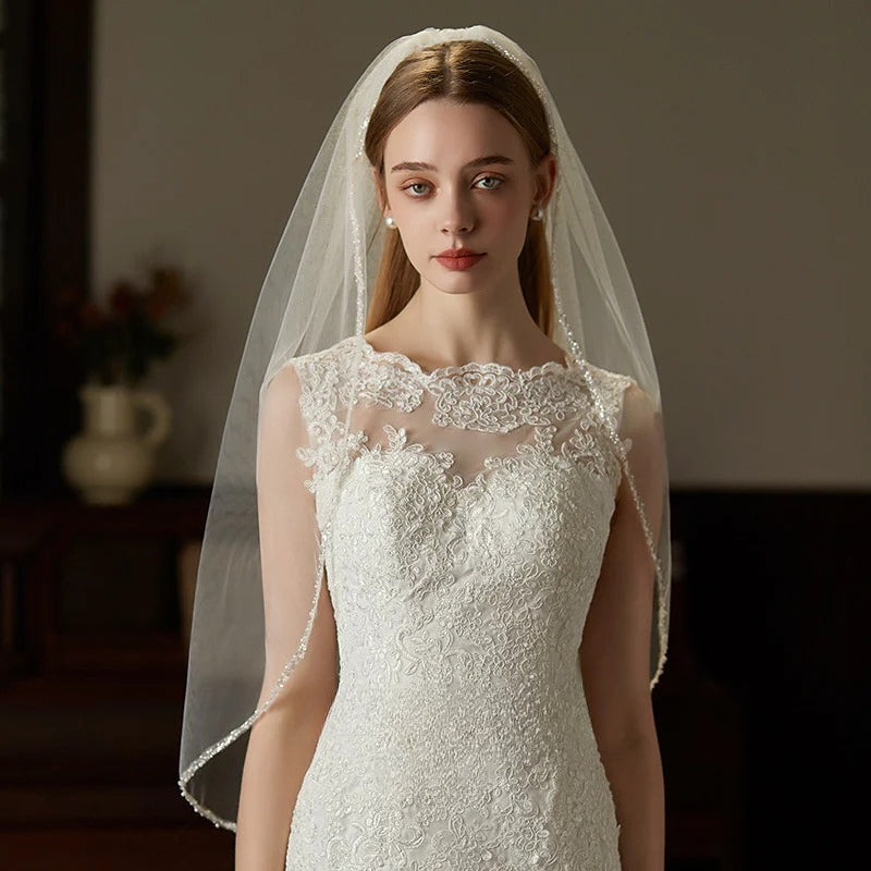 Handcrafted beaded hair comb with mid-length tulle bridal veil, elegant and lightweight wedding headpiece