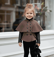Girl wearing black wool cape coat baby doll style winter outerwear for ages 4 to 7 years