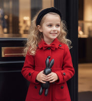 Girl wearing elegant red cashmere long coat with black bow detail for autumn winter ages 3-5 years