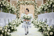 Young girl wearing a grey floral off-shoulder dress with subtle sheen and A-line silhouette for elegant occasions