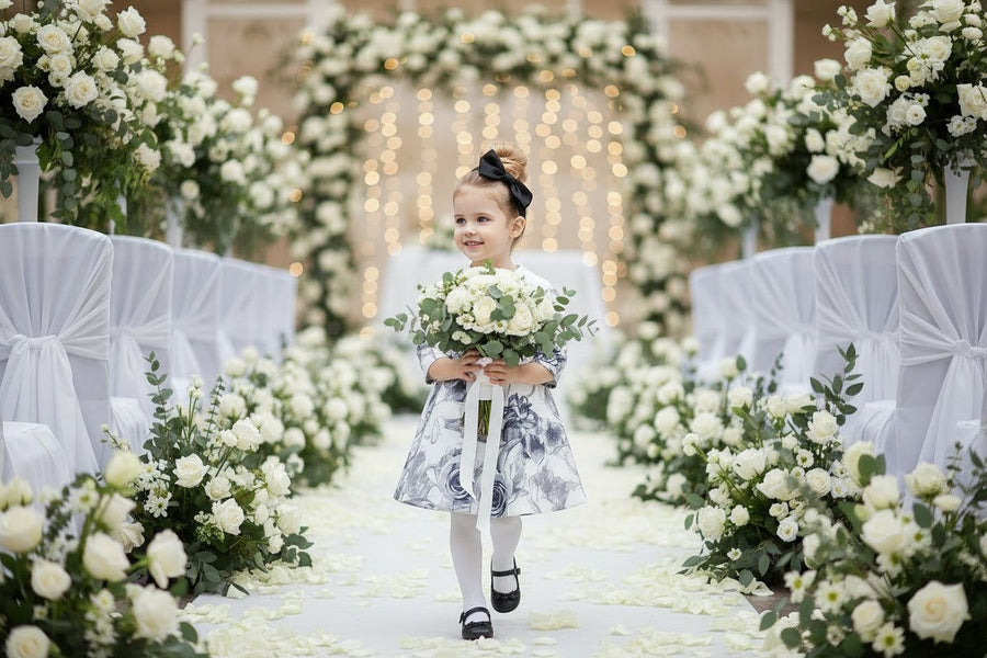 Young girl wearing a grey floral off-shoulder dress with subtle sheen and A-line silhouette for elegant occasions