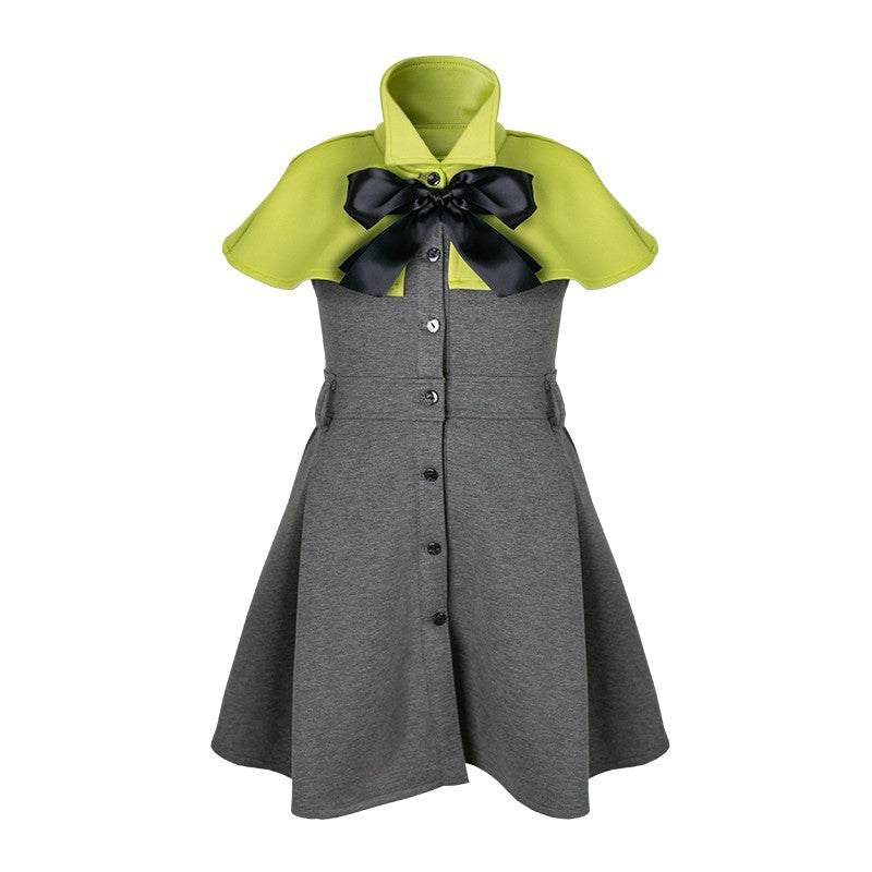 Girl wearing elegant apple green cape flower girl dress with black bow