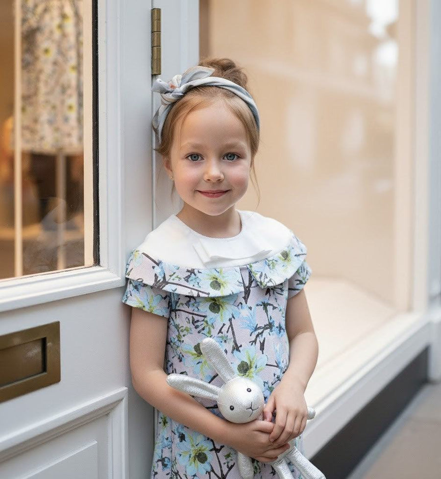 Toddler girl wearing elegant floral princess dress with removable sleeves at birthday party