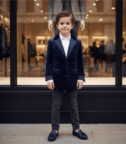 Boy wearing navy velvet blazer with tailored fit and classic lapels for formal and everyday elegance