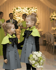 Apple green cape flower girl dress with black bow for girls aged 9-12 at a wedding ceremony