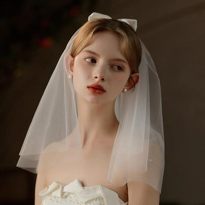 Ivory Bow Bridal Veil made of soft chiffon tulle with elegant knot accent for weddings