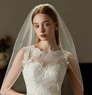 Beaded hair comb with handcrafted mid-length tulle bridal veil on wedding headpiece