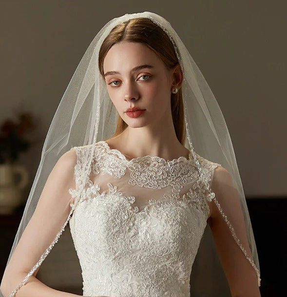 Beaded hair comb with handcrafted mid-length tulle bridal veil on wedding headpiece