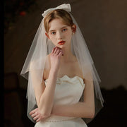 Double-layer mid-length bridal veil with satin ribbon bow on soft chiffon tulle