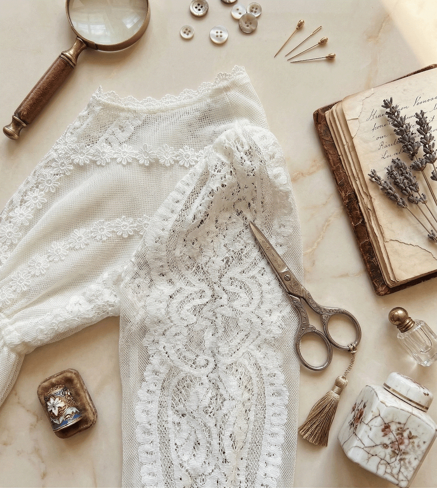 Toddler girl wearing long white lace fairy dress with vintage floral design for special occasions