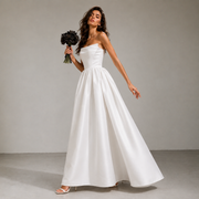 Elegant satin strapless wedding dress with sculpted bodice and full skirt in minimalist bridal design