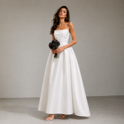 Elegant satin strapless wedding dress with sculpted bodice and full skirt in minimalist French bridal style