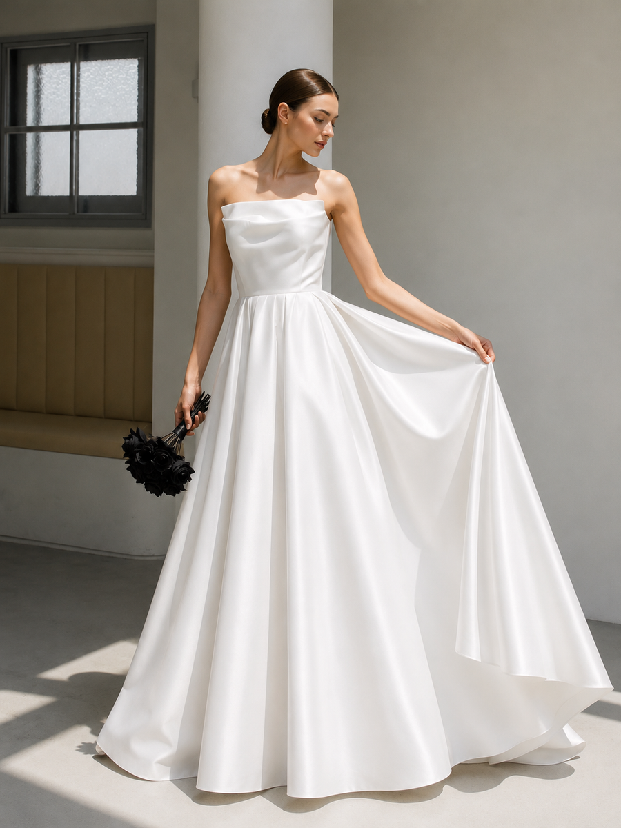 Elegant satin strapless wedding dress with sculpted bodice and full skirt in minimalist bridal style