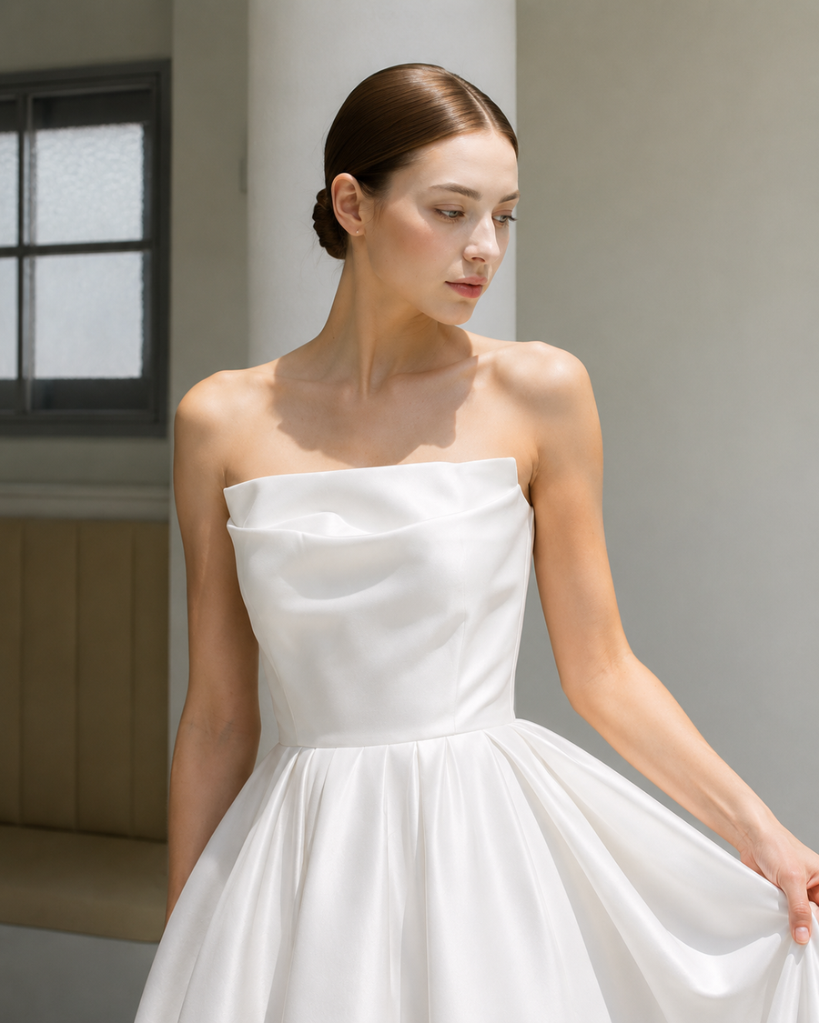 Elegant satin strapless wedding dress with sculpted bodice and full skirt in minimalist bridal design