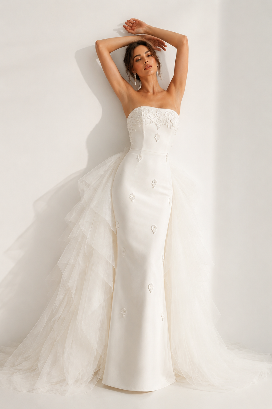 Ivory pearl satin formal wedding dress with sculpted floral appliqué and detachable tulle train