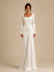 Ivory satin wedding guest dress with floral appliqué and long sleeves