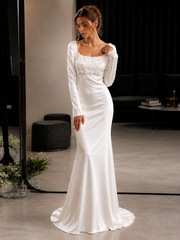 Ivory floral appliqué satin long sleeve wedding guest dress with sculpted waist and floor-length silhouette