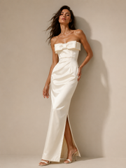 Ivory satin strapless evening gown with bow detail and minimalist column silhouette