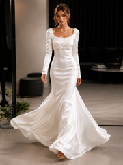 Ivory floral appliqué satin wedding guest dress with sculpted waist and long sleeves