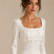 Ivory satin wedding guest dress with 3D floral appliqué and long sleeves