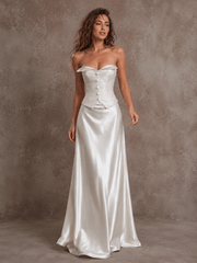 Elegant ivory satin corset wedding dress with ruched bodice and flowing train