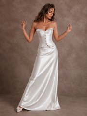 Ivory satin corset wedding dress with ruched bodice and flowing train on model