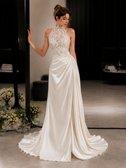 Ivory lace halter dress with sheer bodice and draped train for elegant wedding look