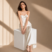 Ivory satin corset evening gown with strapless bow and floor-length silhouette