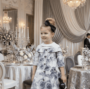 Young girl wearing grey floral off-shoulder dress with A-line silhouette and subtle sheen