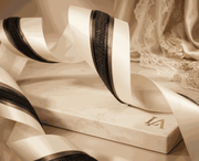 Ivory and charcoal satin ribbons set with layered widths for elegant gift wrapping and wedding styling