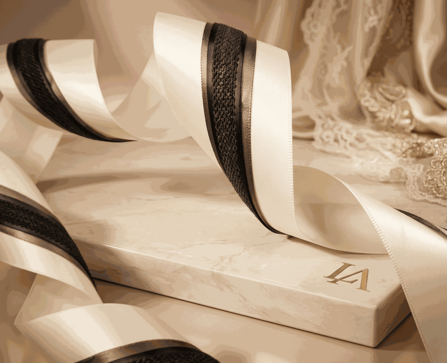 Ivory and charcoal satin ribbons set with layered widths for elegant gift wrapping and wedding styling