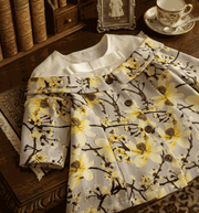 Girl wearing a grey floral off-shoulder dress with A-line silhouette and subtle sheen