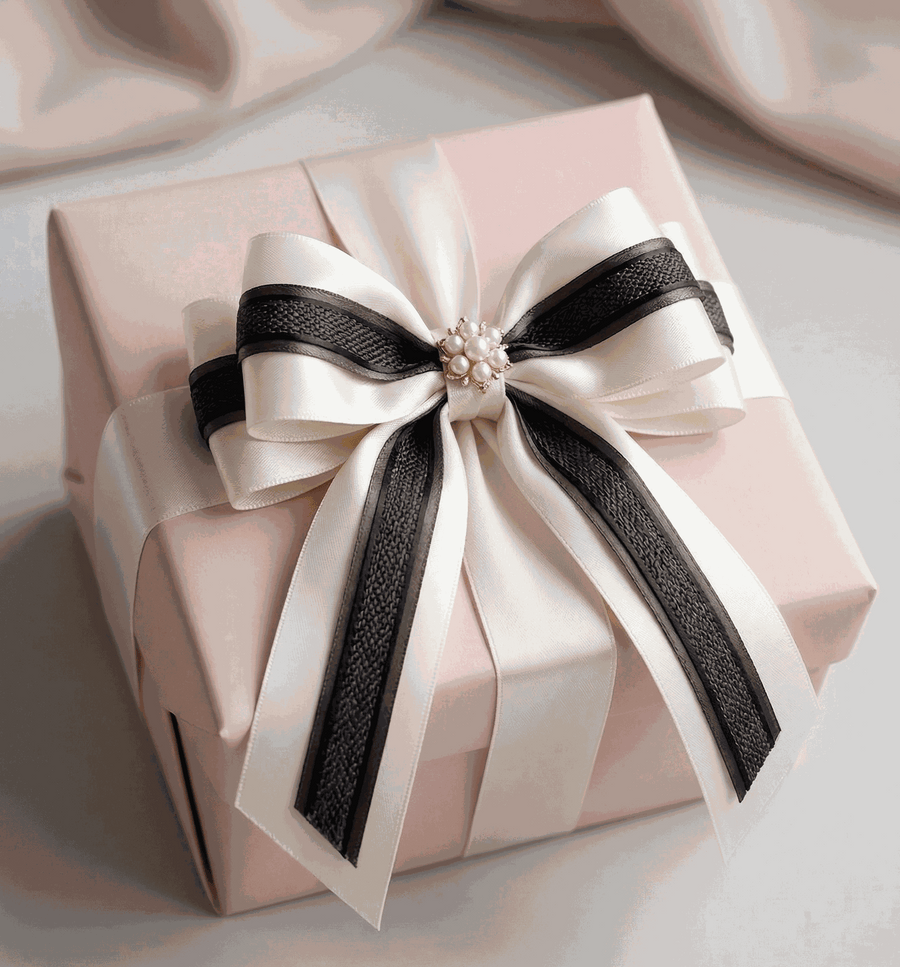 Ivory and charcoal satin ribbons styled for elegant wedding and gift decoration
