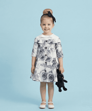Girl wearing a grey floral off-shoulder dress with a subtle sheen and A-line silhouette for special occasions and everyday elegance